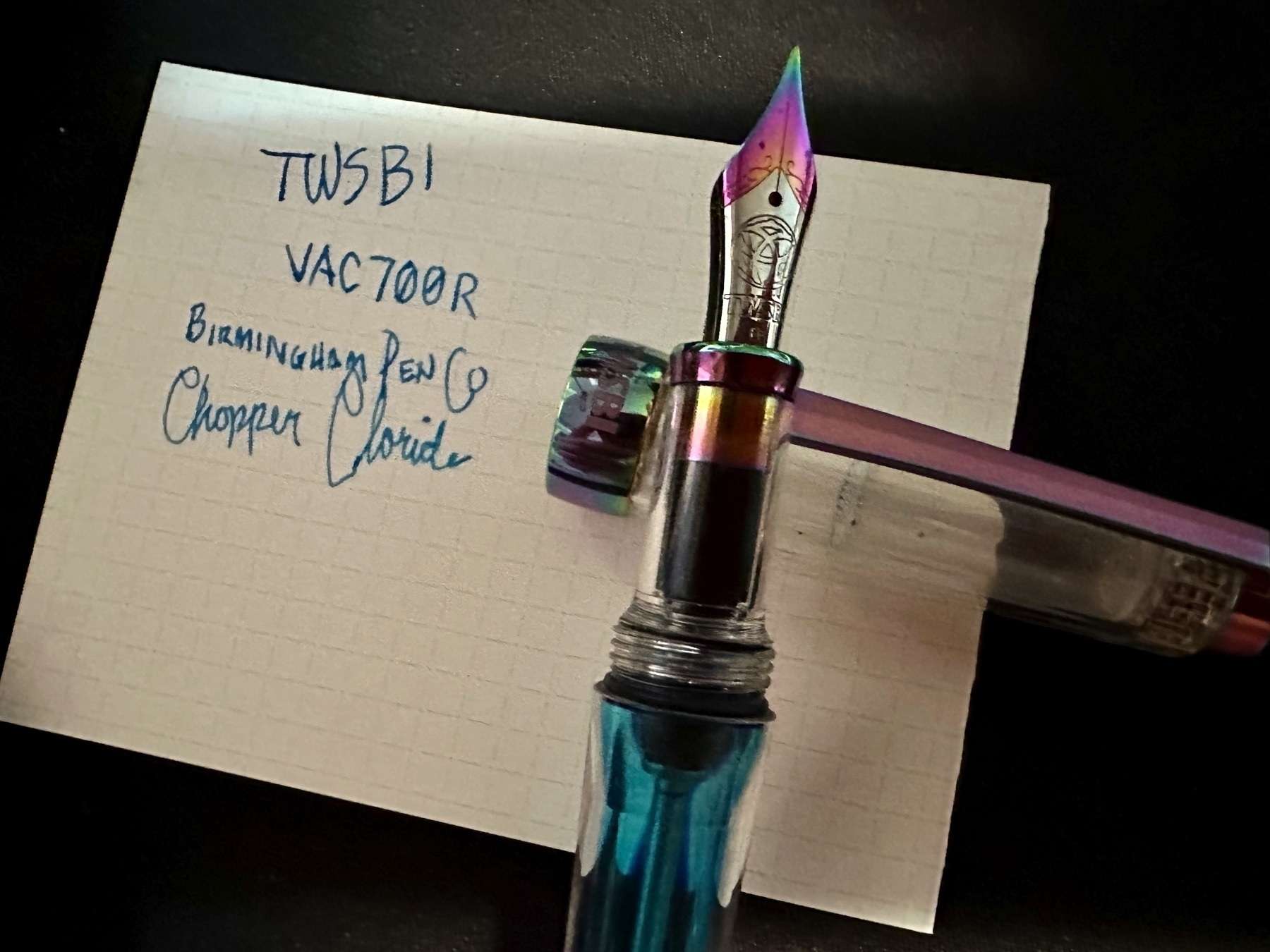 A TWSBI 700R uncapped over a card that says “TWSBI VAC700R with Birmington Pen Co Copper Choride.”